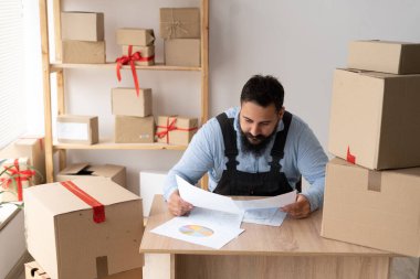 indian delivery small business owner working at home office with paperwork, SME shipping, online telemarketing, seller entrepreneur sale, small business concept