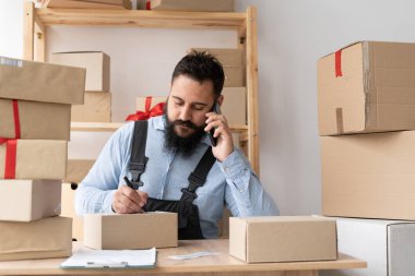 indian entrepreneur small business owner taking order using smartphone, small or medium business delivery, e-commerce, telemarketing, start-up shipping, copy space