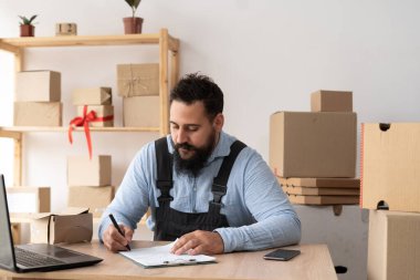Small business aspiring indian entrepreneur, medium business freelance worker working in home office using computer, mail delivery business start-up, online shopping, e-commerce, copy space