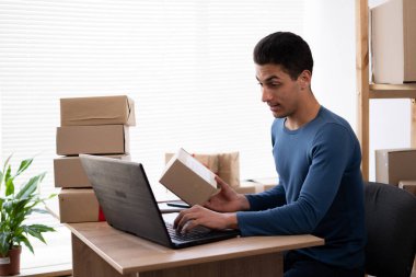 Small business aspiring entrepreneur, small and medium business freelance working in home office using computer, online marketing packaging box delivery, SME e-commerce telemarketing