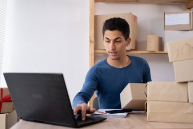 Start up entrepreneur asian man working with box for packaging order from shopping online. delivery packaging box on table, small business owner working at home office, SME, shopping online concept