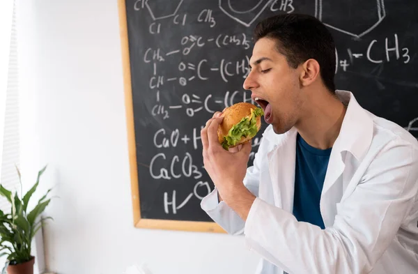 Asian Worker Food Control Eating Hamburger Workplace While Checking Quality — Stock Photo, Image