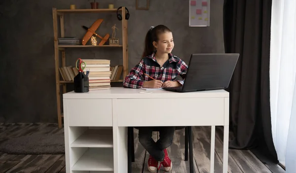 Online remote learning. School kids with computer having video conference chat with teacher. Child studying from home. Homeschooling.