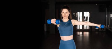 Hispanic fitness woman with dumbbells in the gym, pump up triceps in training, banner, space for text