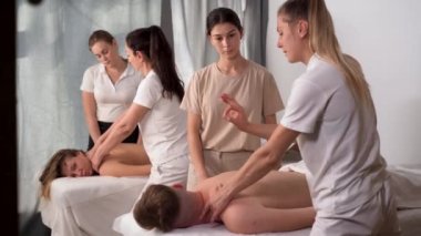 Massage training concept. the master teacher to show in practice to the student what movements should be performed when massaging the muscles of the neck. copy space.