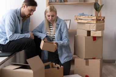 Unhappy woman client dissatisfied by parcel, looking in open cardboard damaged box, crushed fragile goods, bad delivery service concept. couple moving into a new home