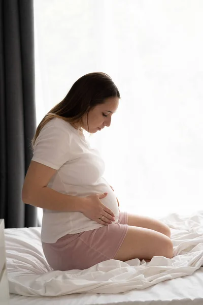 Happy Pregnant Woman Touching Her Belly Sitting Bed Pregnancy Motherhood — Fotografia de Stock