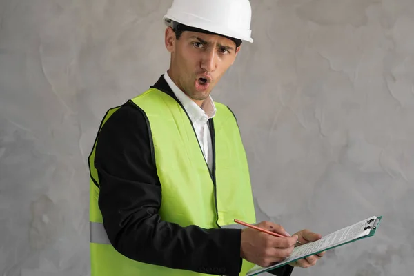 Angry muslim worker, Inspector or engineer is checking and inspecting the building or house by using checklist. An engineer man making notes on his clipboard in a factory. Concept of Industry