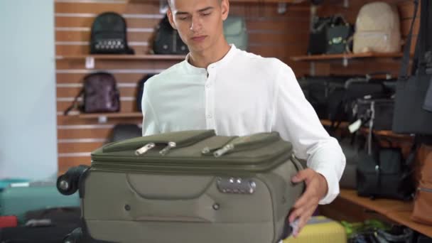 Young Caucasian Man Shirt Chooses Travel Fabric Suitcase Haberdashery Store — 비디오