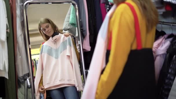 Portrait Lady Choosing Clothes Store Stands Mirror Applies Womens Clothes — Stok Video