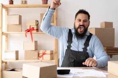 Angry screaming small business owner at home office, upset emotional businessman entrepreneur at table, anger and aggression concept