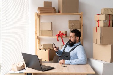 Shipment Online sales, delivery service of small business owner or SME and work packing box, small business owner working in home office using laptop, accepting orders online, copy space