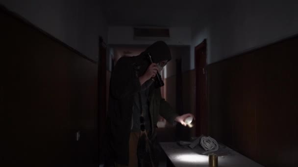 Man Clothes Hood Gas Mask Walking Old Abandoned Corridor Flashlight — Stockvideo