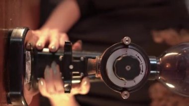 first stage of brewing filtered coffee. barista put the brewer sets the coffee filter and pours hot water from a special kettle on it. Close-up, no face. vertical video