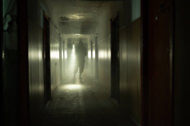 Brave post apocalyptic survivor with gas mask and flashlight walk on building. environmental disaster, crime and chemical warfare concept