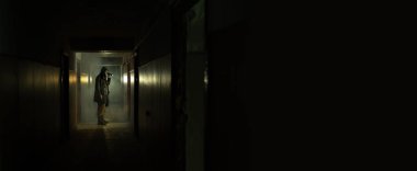 Brave post apocalyptic survivor with gas mask and flashlight. environmental disaster, crime and chemical warfare, nuclear winter concept