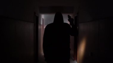 Environmental pollution, environmental disaster, nuclear war, post apocalypse concept. Caring for future generations. A man in gas mask with a flashlight explores corridor of an old abandoned building