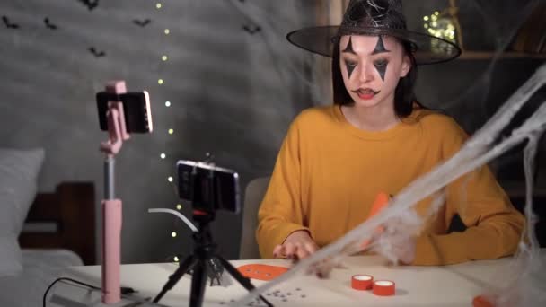Young Woman Witch Blogger Writes Video Blog Making Paper Pumpkin — ストック動画