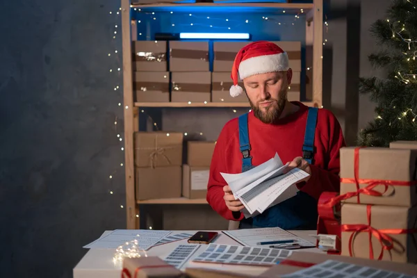 Shipment Online Sales, Small business or SME entrepreneur owner delivery service and working packing box on Christmas, business owner Santa Claus working checking order to confirm in post office.