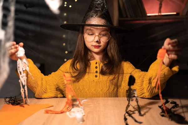 Cute Happy Little Girl Preparing Halloween Making Skeleton Garland While — стоковое фото