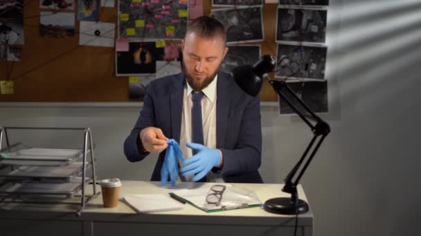 Young Serious Male Detective Uniform Workplace Documents Evidence While Learning — Stock Video