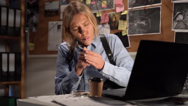 侦探在她办公室的办公桌前工作用笔记本电脑 抽烟喝咖啡 — 图库视频影像