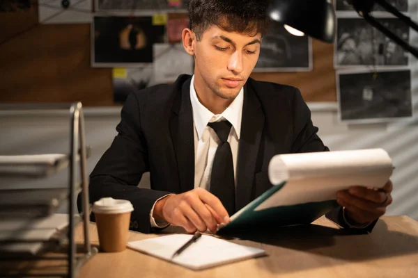 Detective working at desk in his office, investigator on workplace, copy space