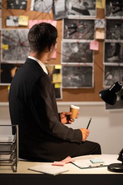 Dedektif ofisindeki araştırma panosuna bakıyor. Çözüm, arka görüş, kopyalama alanı arıyor.