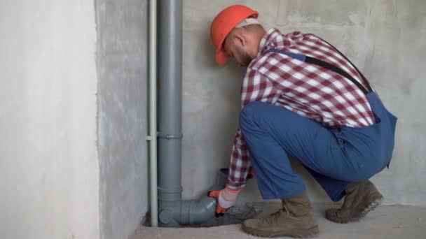 Bearded Young Plumber Fitting Pvc Sewage Pipes Newly Built House — Stock Video