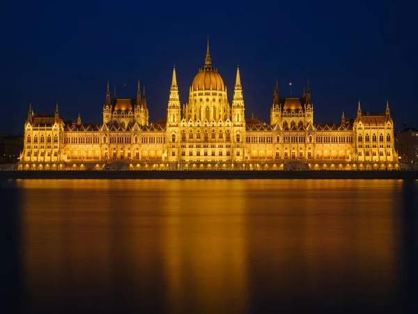 Parliament building in Budapest, Hungary. Parliament and reflections in the Danube River. Evening illumination of the building.