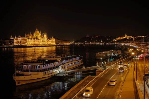 Panoramic view of Parliament building and the Danube River in Budapest, Hungary. Parliament and reflections . Evening illumination of the building.