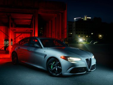 Kyiv, Ukraine - April 10th 2021: ALFA ROMEO Giulia Quadrifoglio in silver metallic color parked near Olimpiyskiy National Sports Complex