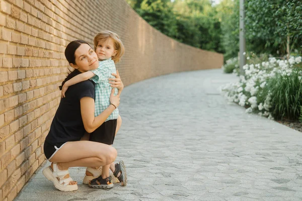 Happy Beautiful Mother Little Son Hug Each Other Posing Park — стоковое фото