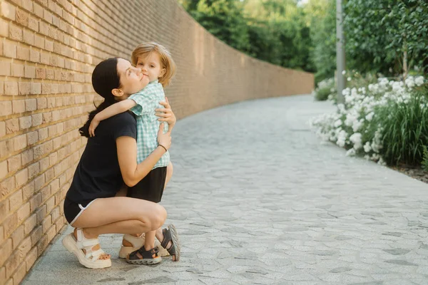 Happy Beautiful Mother Little Son Hug Each Other Posing Park — стоковое фото