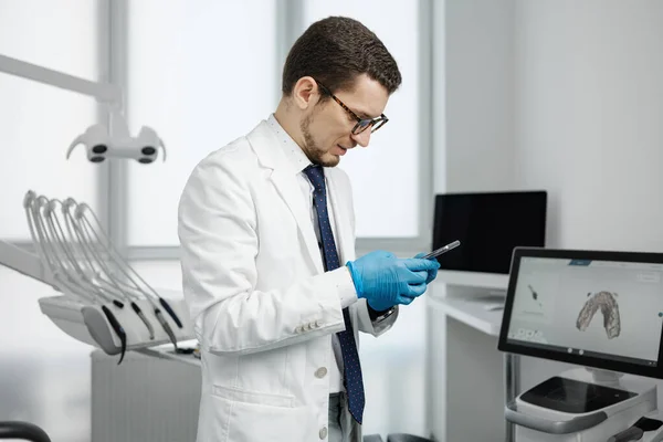 Handsome Male Dentist Wearing Eyeglasses White Coat Holding Smartphone Looking — ストック写真