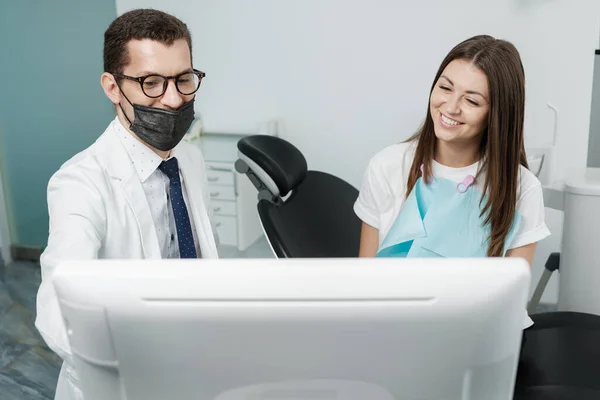 Male Orthodontist Female Patient Looking Screen Dental Consultation Visit — Stock Photo, Image