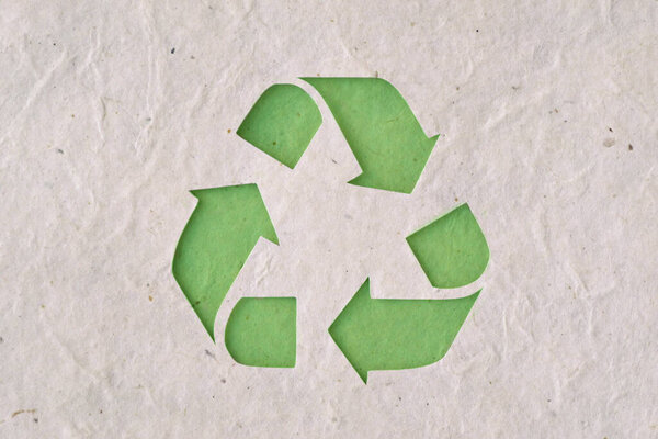 Recyclig symbol on recycled paper - Ecology concept