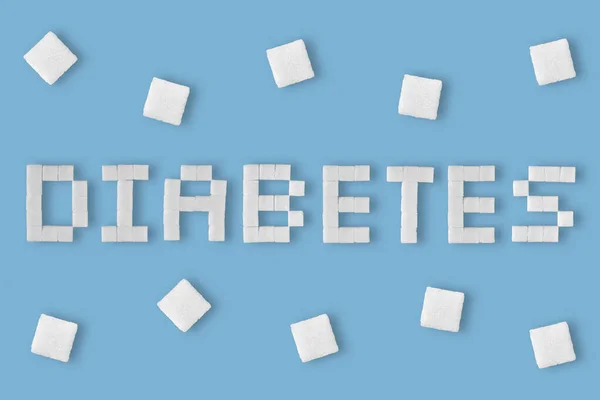 Word Diabetes Skriven Med Sockerbitar Blå Bakgrund — Stockfoto