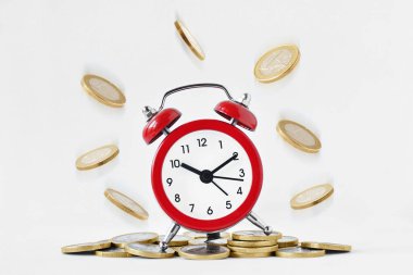 Alarm clock with falling coins on white background - Time is money concept