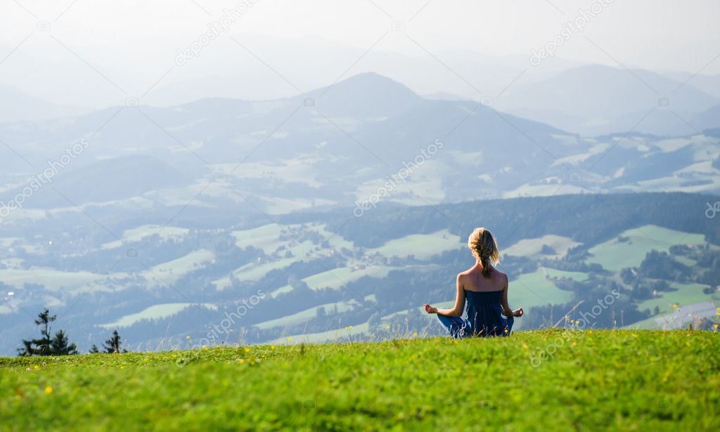 Young woman meditating outdoors