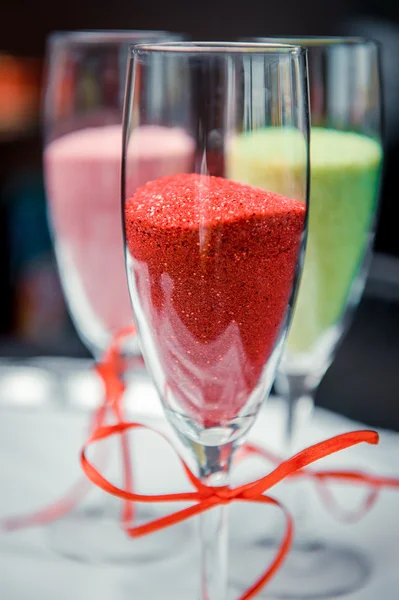 Champagne glasses with red bows decor — Stock Photo, Image