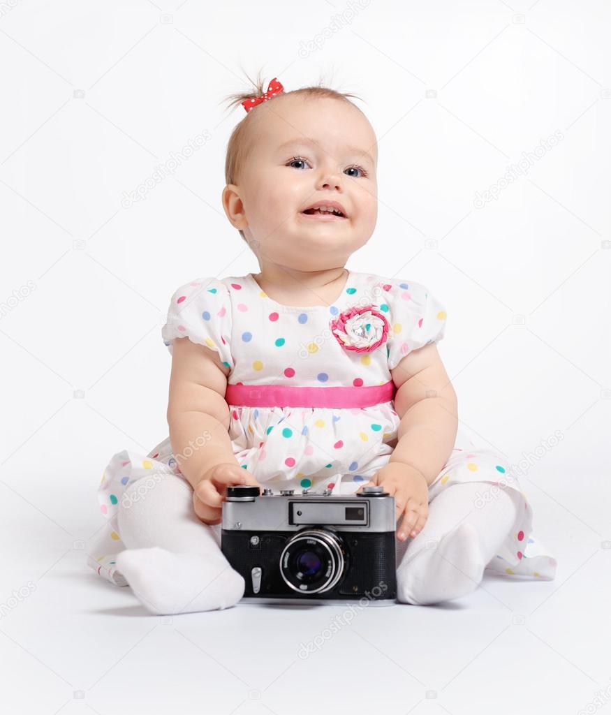 Adorable baby with retro camera