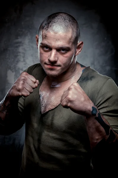 Portrait of young fighter with dirty face and chest — Stock Photo, Image