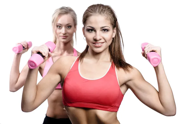 Two attractive athletic girl with dumbbells — Stock Photo, Image