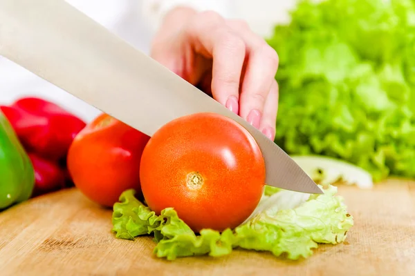 Woman cutting vegetables for a salad — Stock Photo, Image