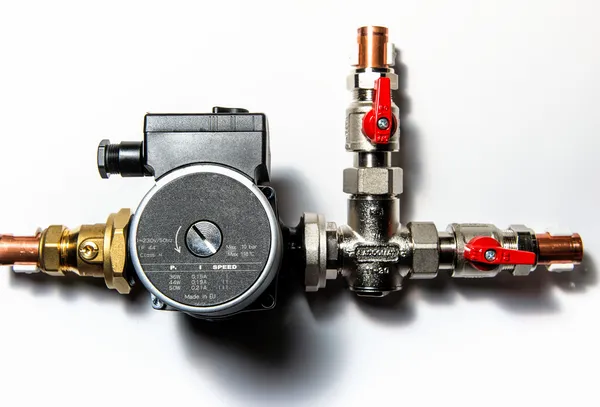 Central heating manifold over white wall — Stock Photo, Image