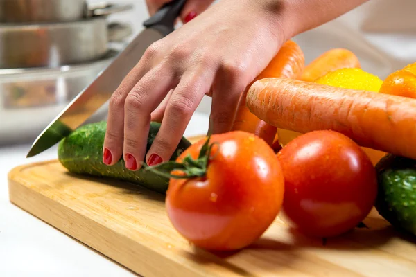 Woman cutting vegetables for a salad — Stock Photo, Image