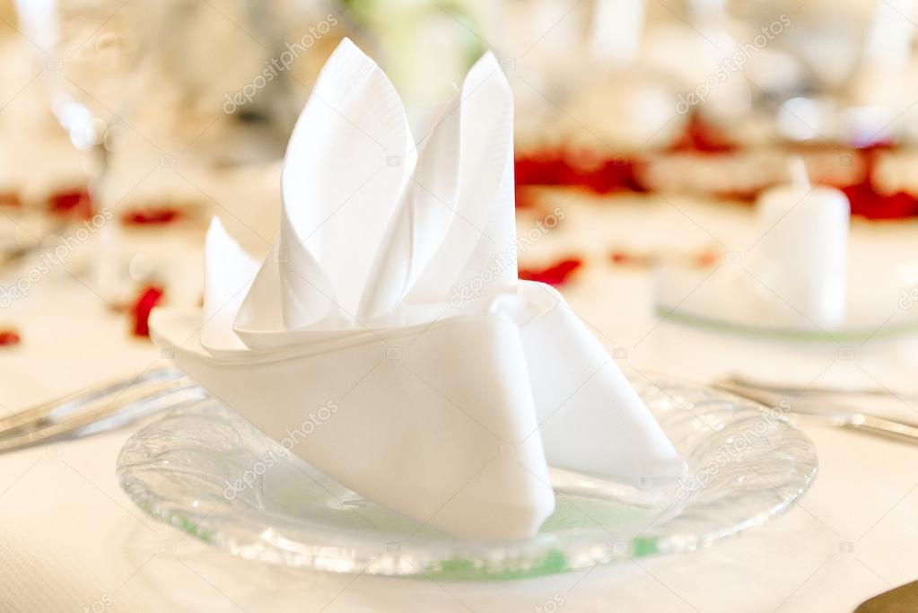 Close-up photo of folded napkin on a table at restaurant