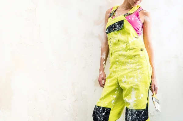 Female in coverall holding paint brush — Stock Photo, Image