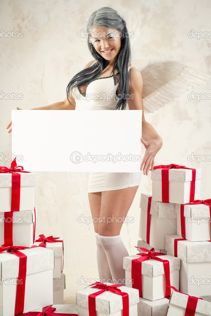 Woman as angel holding empty white board